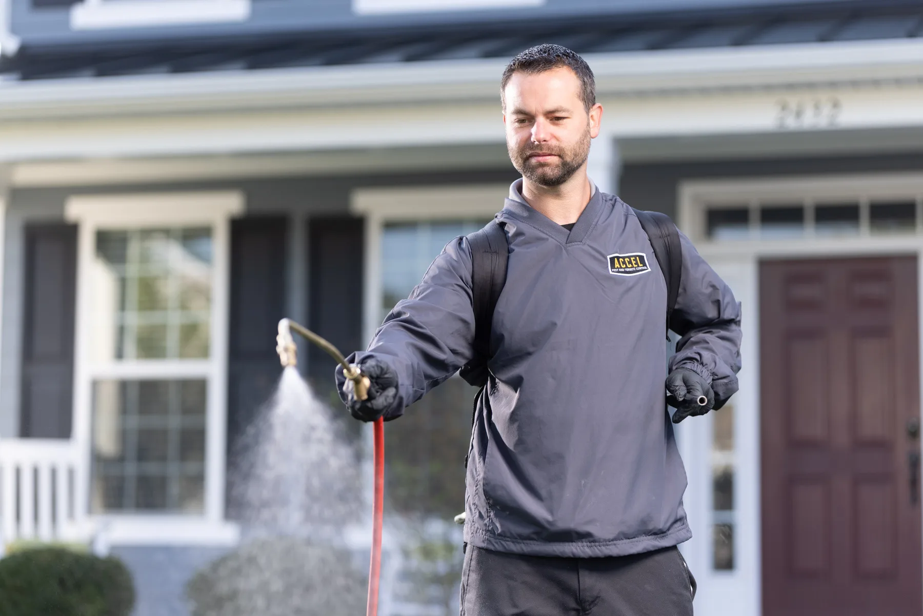 Man spraying fertilizer on a lawn.
