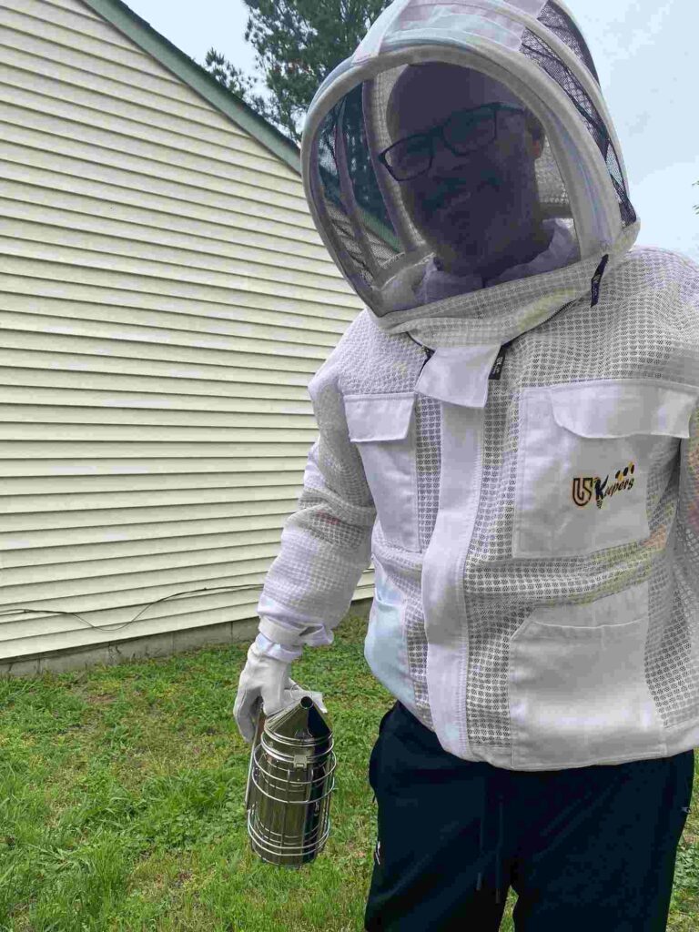 A bee removal expert from Accel Pest and Termite Control gets ready to apply a treatment.